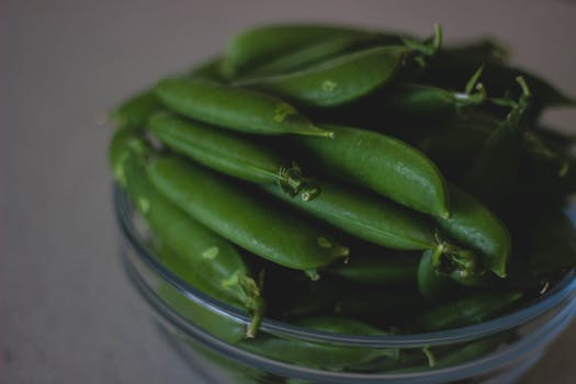A close-up shot of fresh green beans in a glass bowl, highlighting their natural freshness.